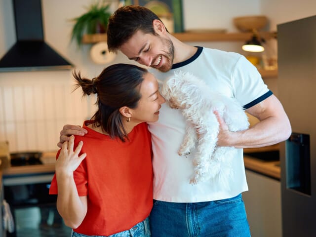 Married couple holding their dog